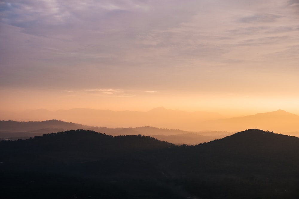 silhouette of mountains during sunset