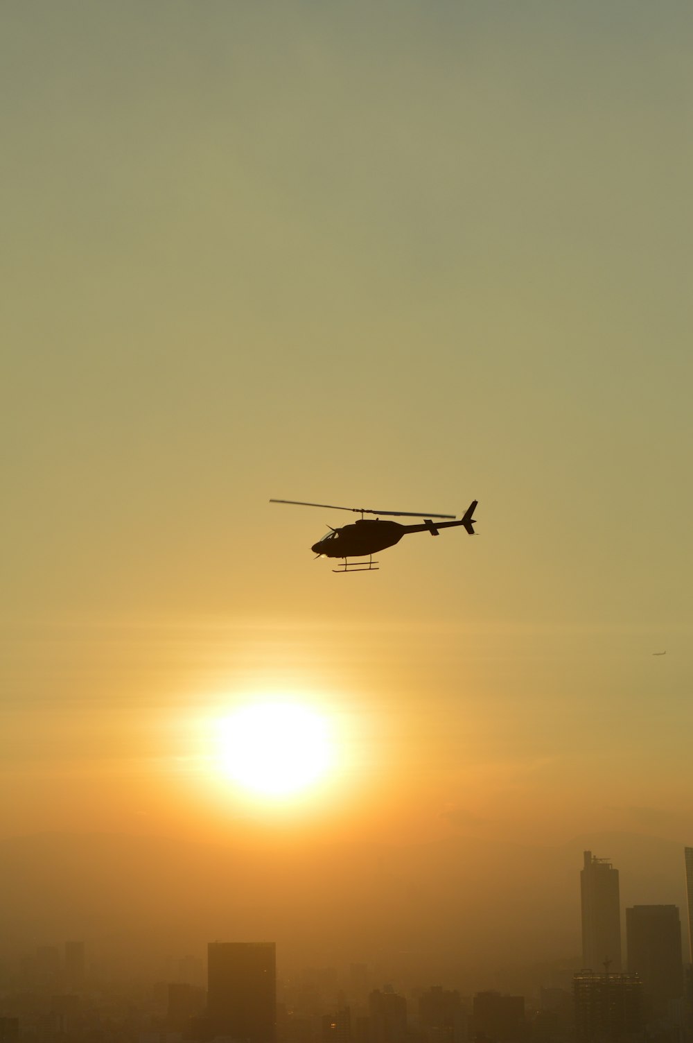 silhouette of flying drone during sunset