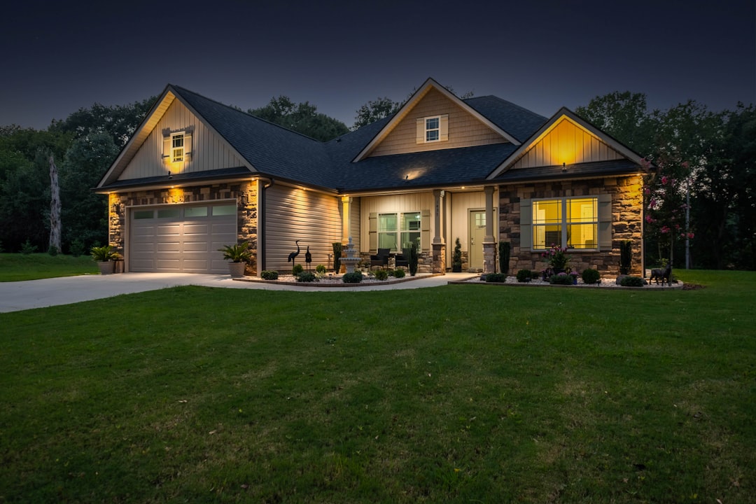 brown and white house near green grass field during night time