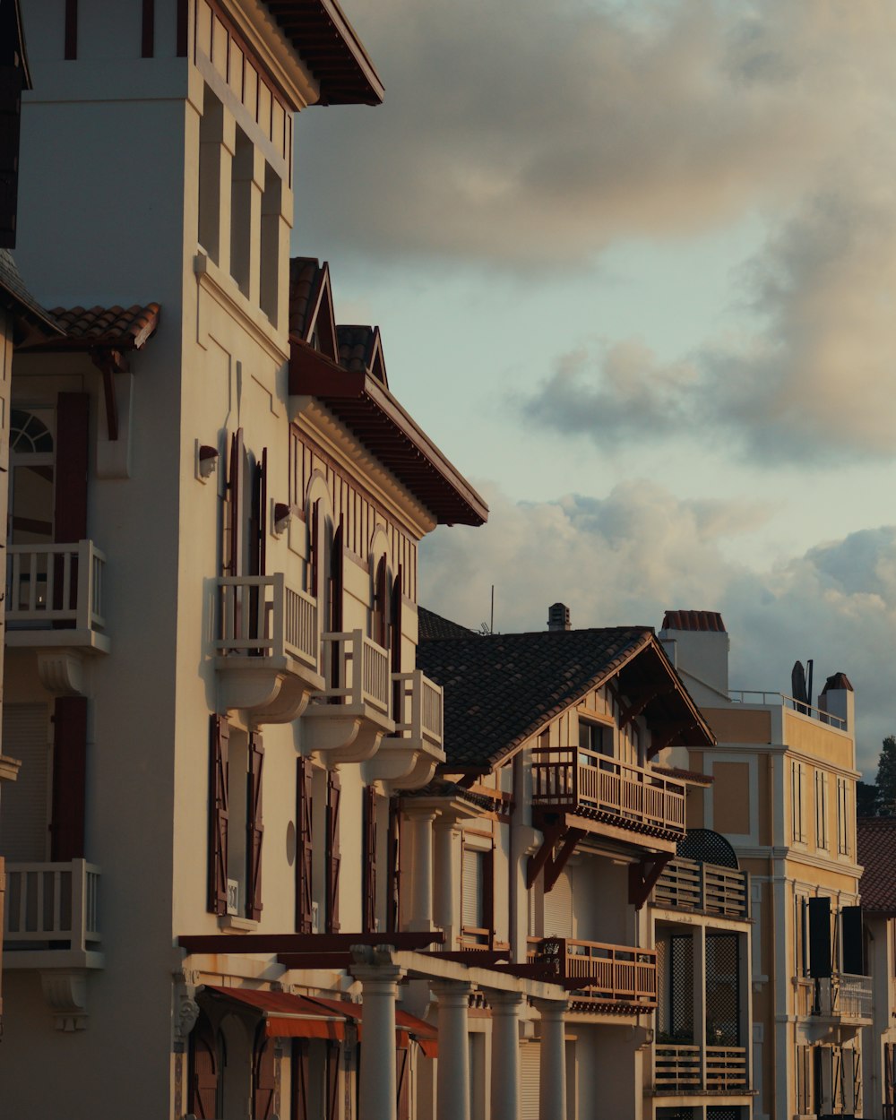 yellow and white concrete buildings under white clouds