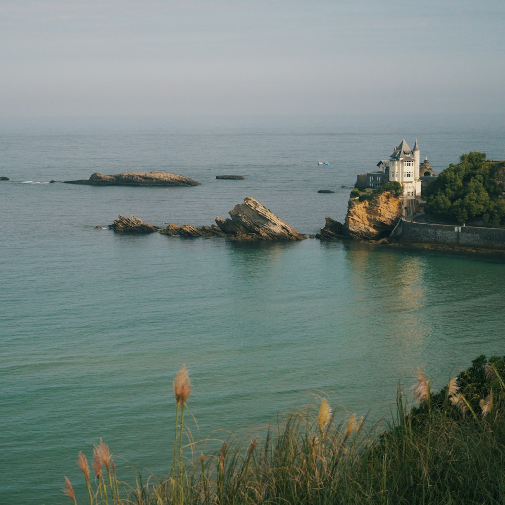 brown and white concrete building on island surrounded by body of water during daytime