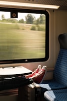 person in red and white sneakers sitting on blue and white chair