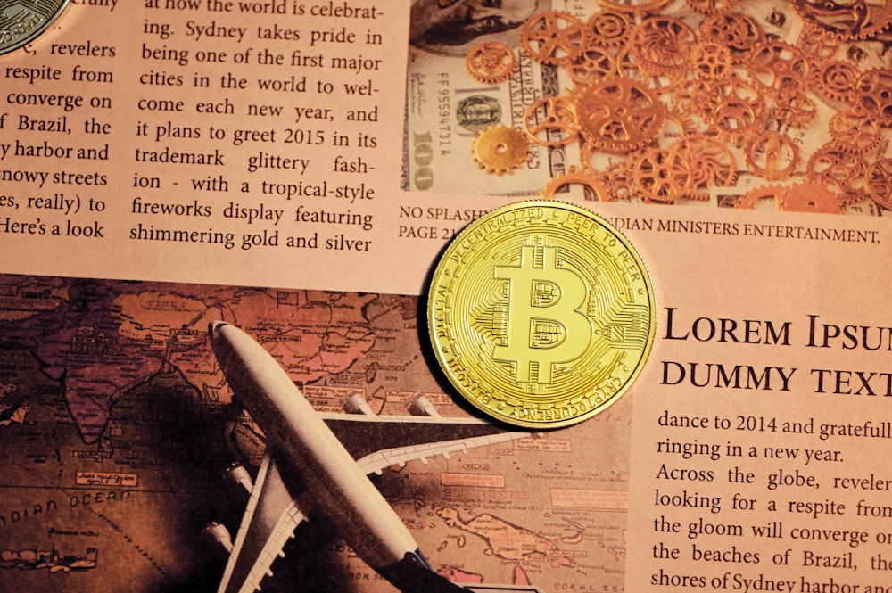 gold round coin on newspaper