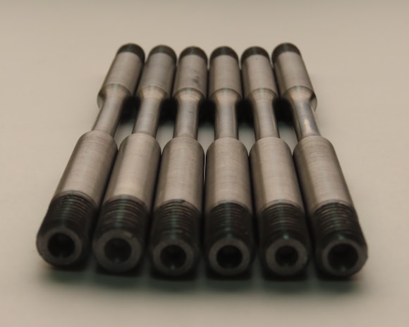Copper rods arranged in bundles, showcasing their smooth finish.