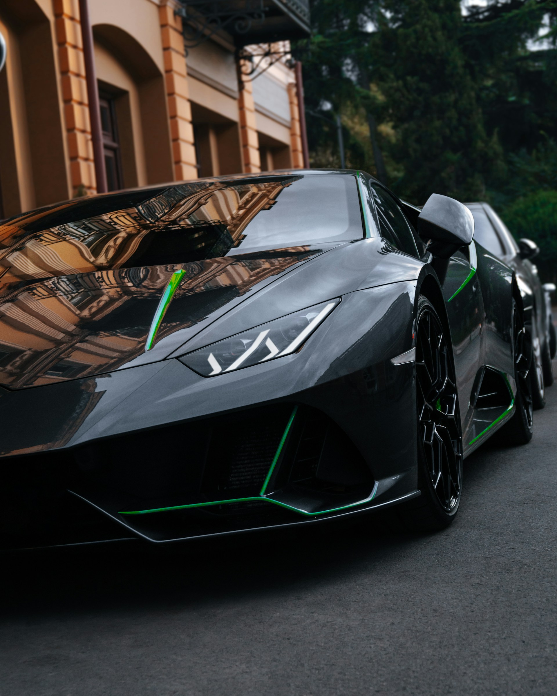 black and white lamborghini aventador parked on gray asphalt road during daytime