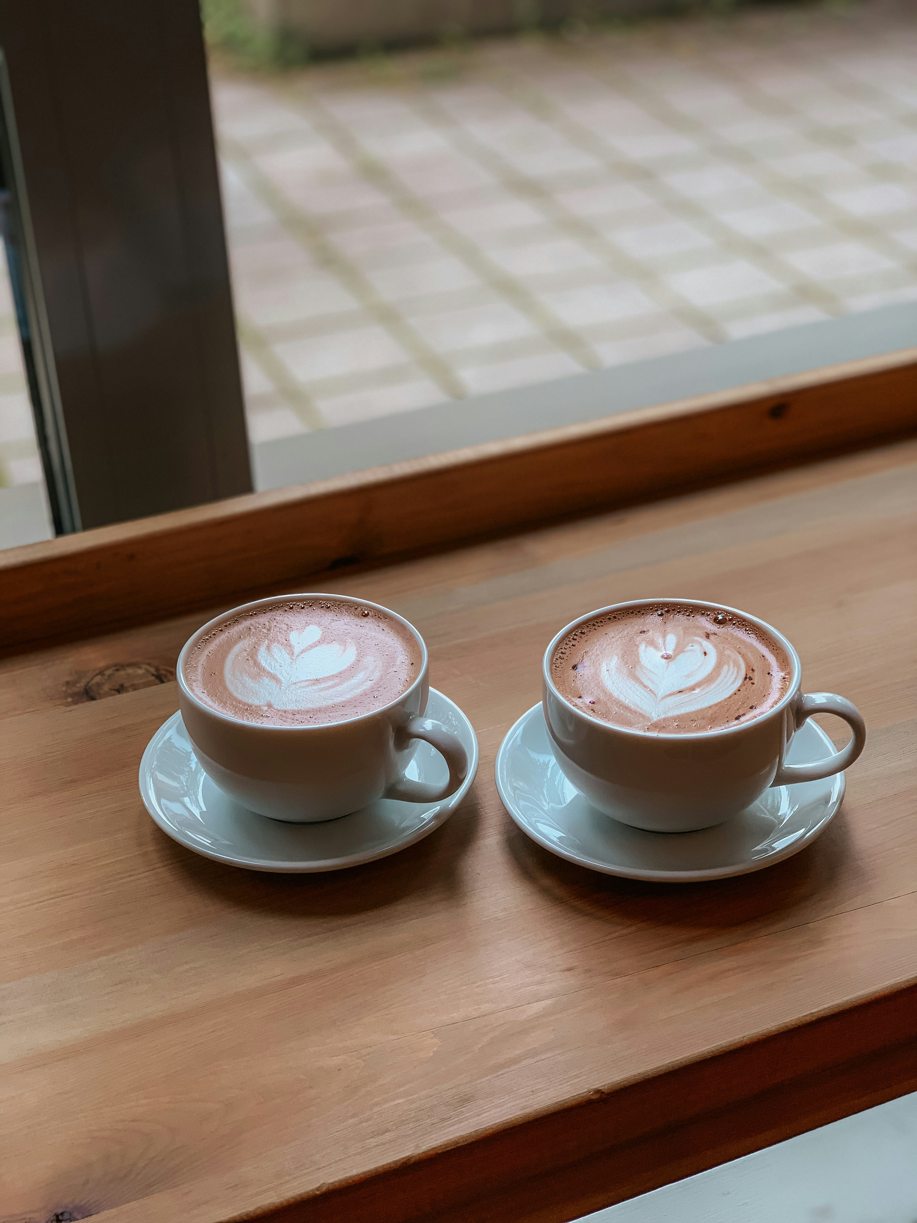 2 white ceramic teacup on saucer