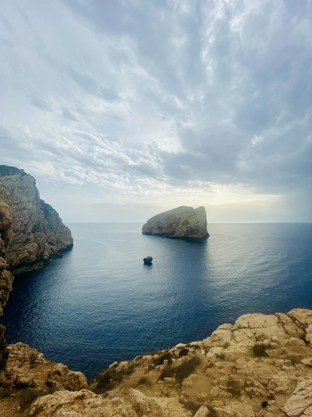 brown rock formation on blue sea under blue sky during daytime