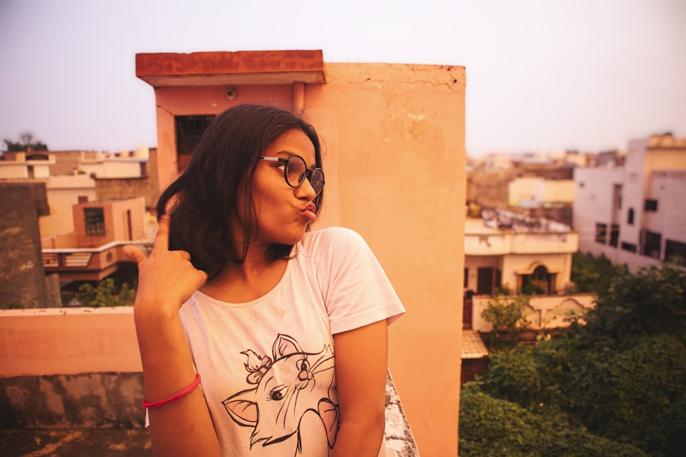 woman in white crew neck t-shirt wearing black sunglasses