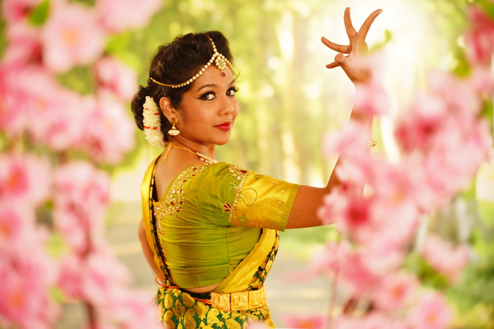 woman in yellow dress standing on pink flower field during daytime