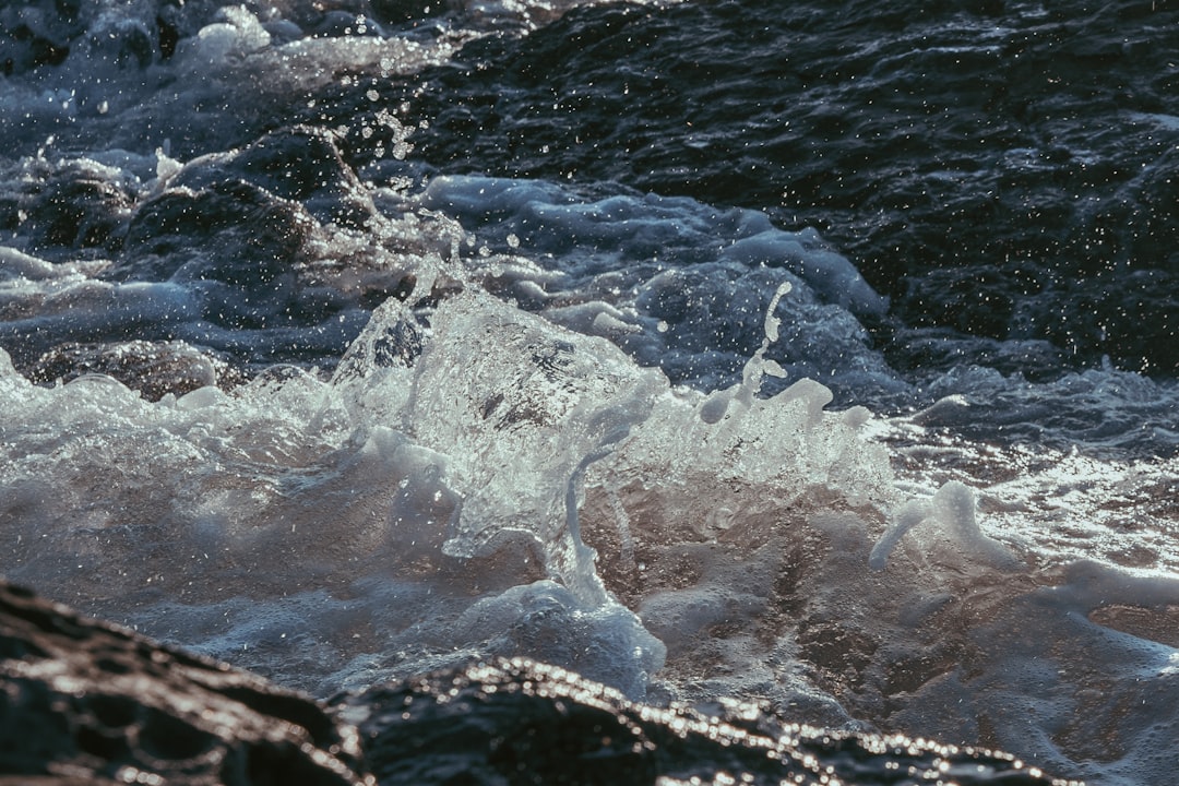 water waves on black rock