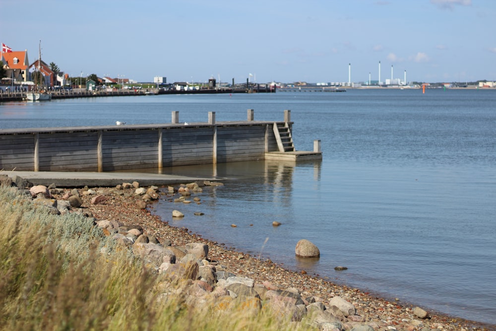 brown wooden dock on blue sea during daytime