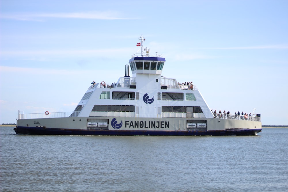 white and black ship on sea under white sky during daytime