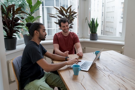 A friendly advisor discussing research plans with a student in a cozy office.