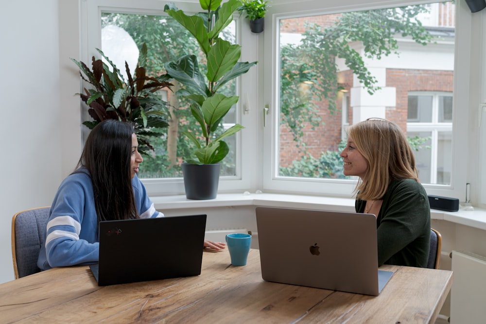 woman in black shirt using macbook