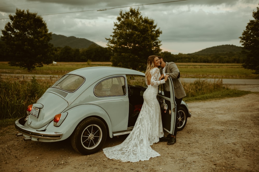 woman in white dress standing beside white car during daytime