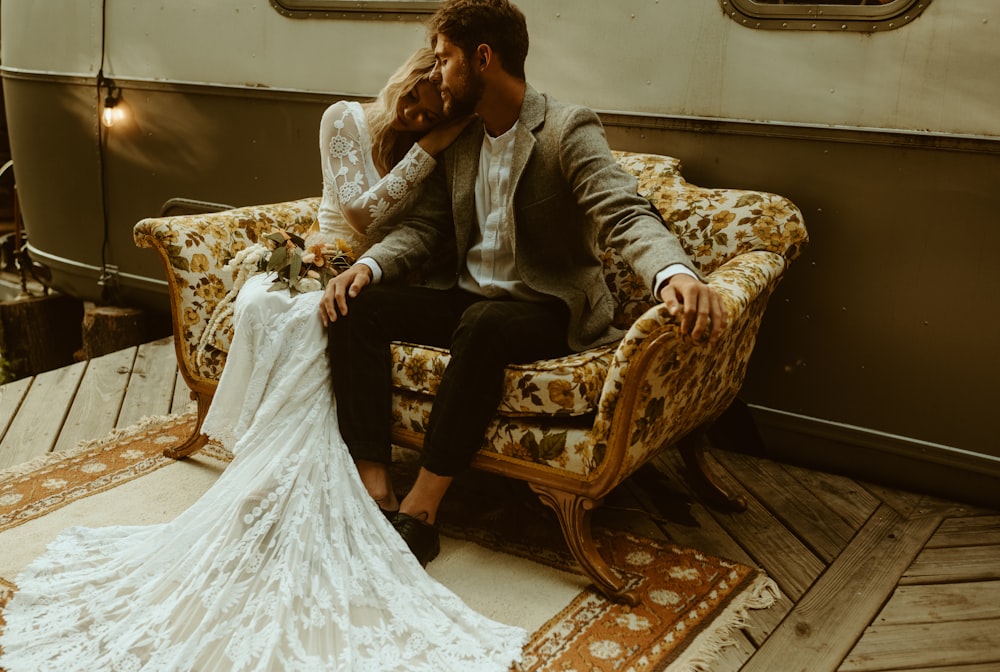 woman in white wedding gown sitting on brown wooden armchair