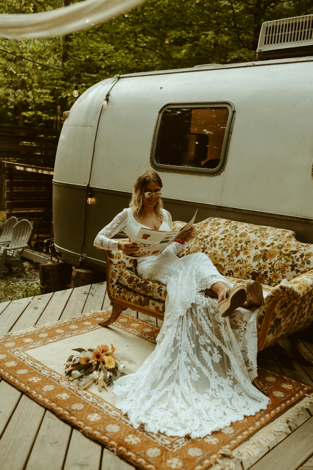 woman in white dress sitting on brown wooden bench