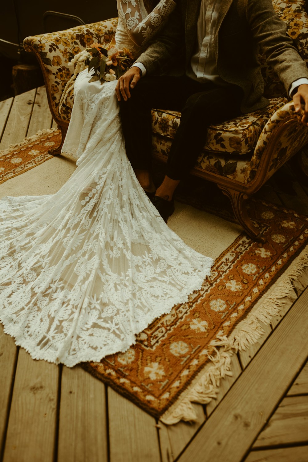 woman in white floral dress sitting on brown and beige floral sofa