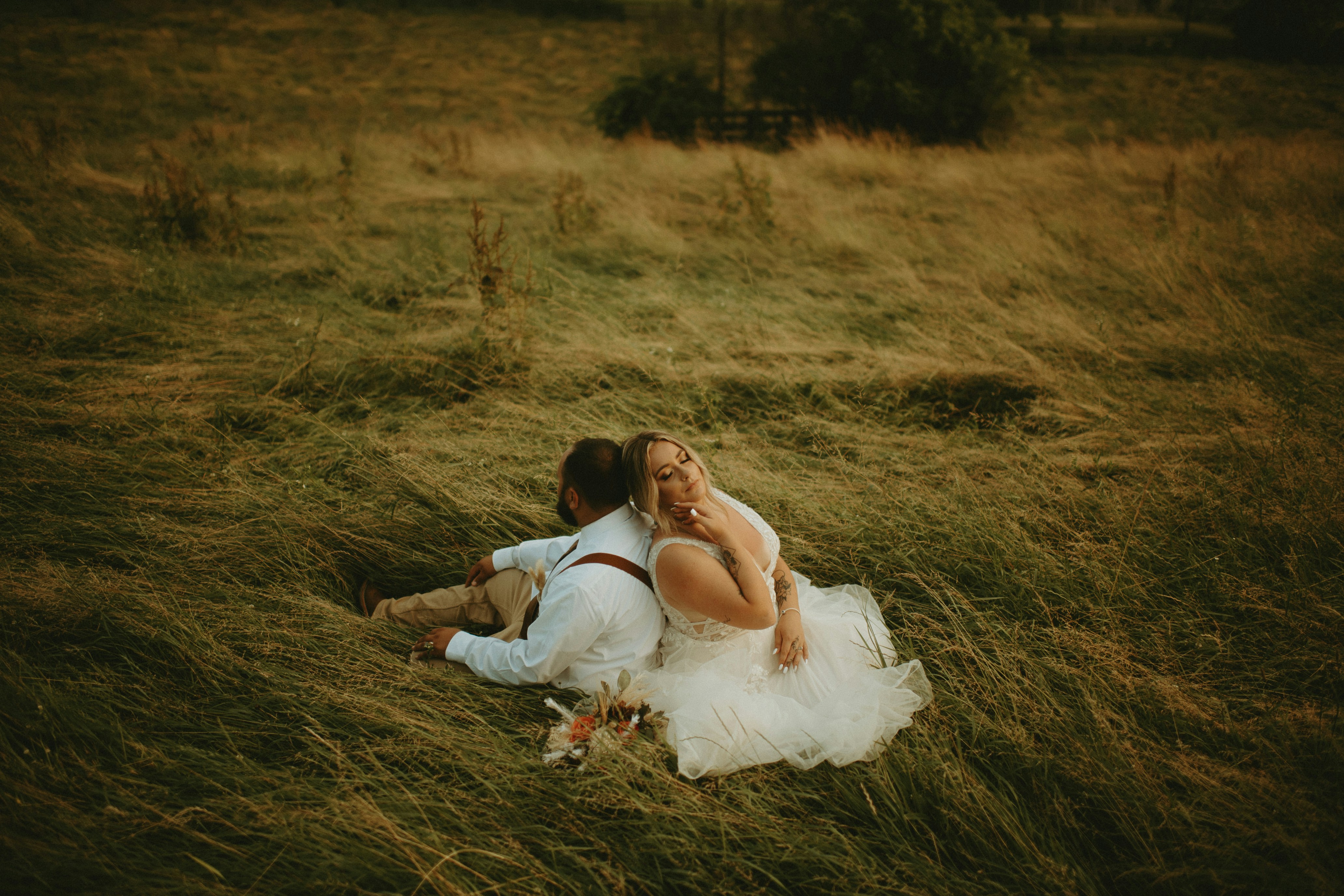 woman in white dress lying on brown grass