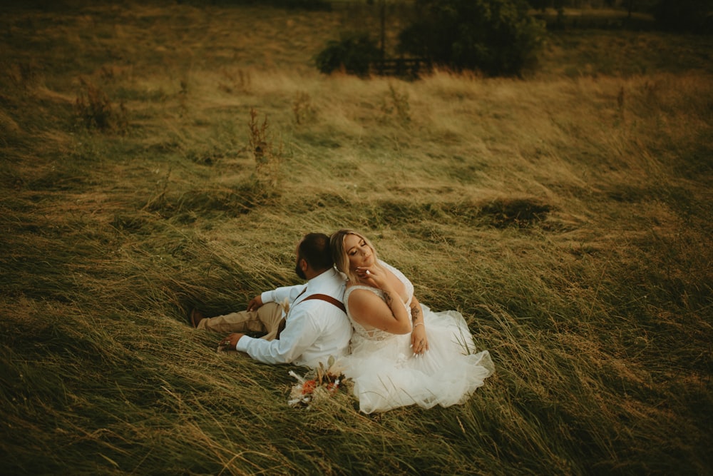 woman in white dress lying on brown grass