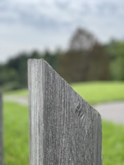 Close-up of a craftsman installing a fence post with care.