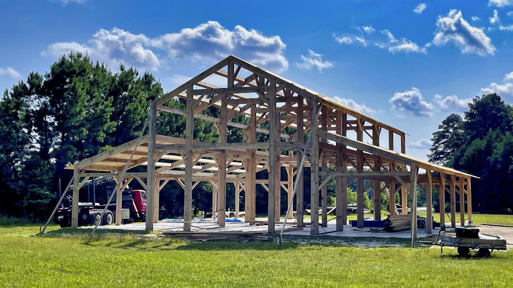 brown wooden building on green grass field during daytime