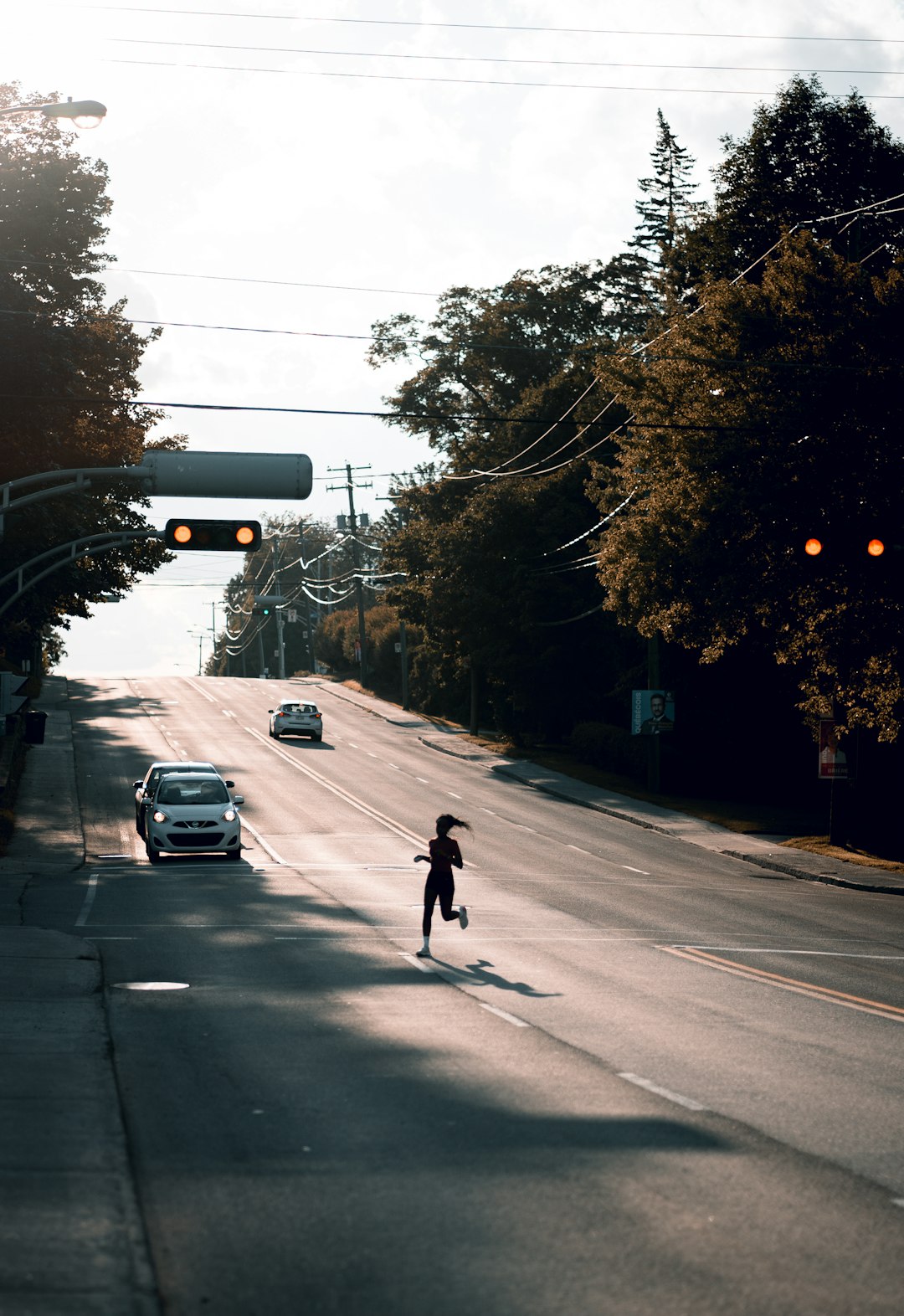 man in black jacket riding bicycle on road during daytime