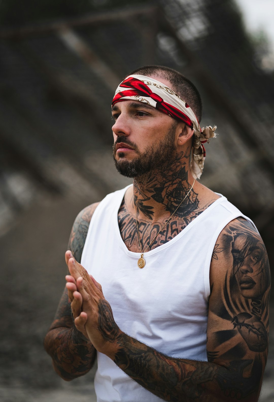 man in white tank top wearing red and white bandana