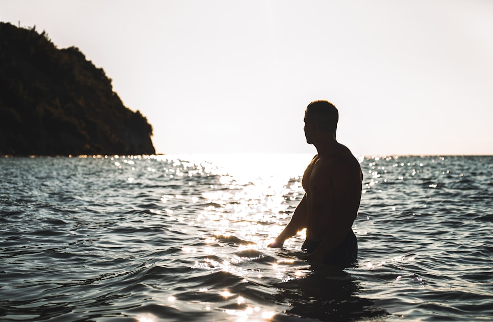 man in body of water during daytime