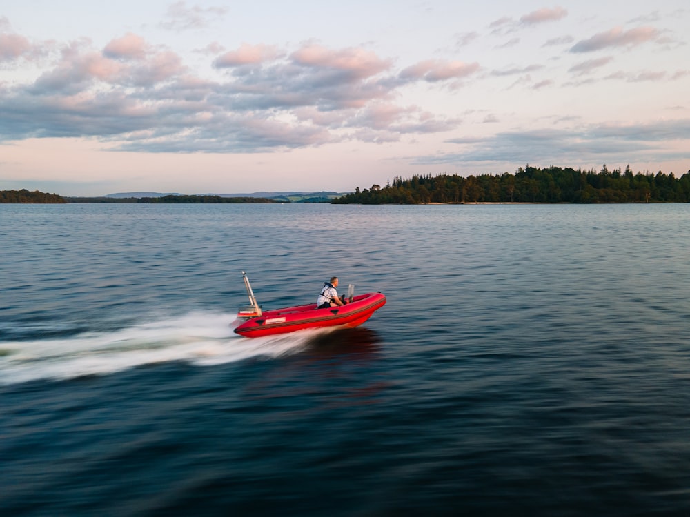 man in red kayak on sea during daytime