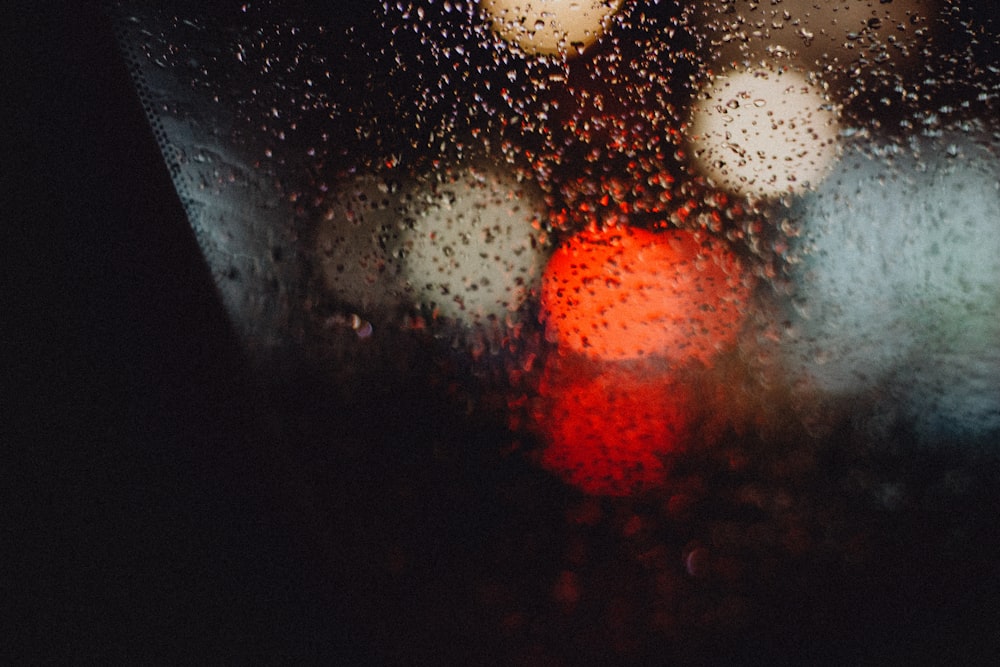 a blurry picture of a red traffic light in the rain
