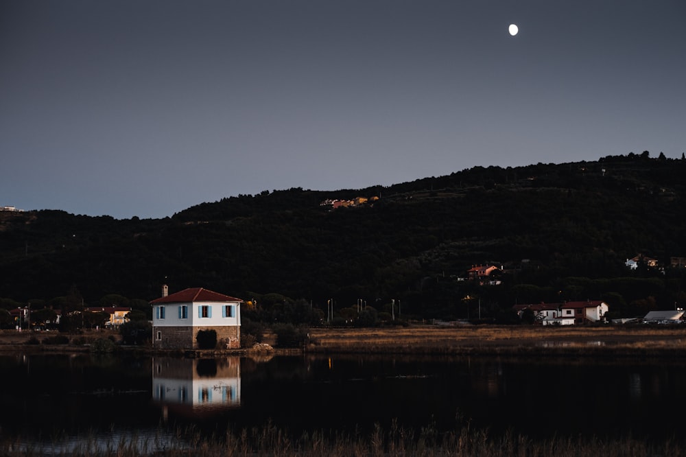 white and brown house near lake during night time