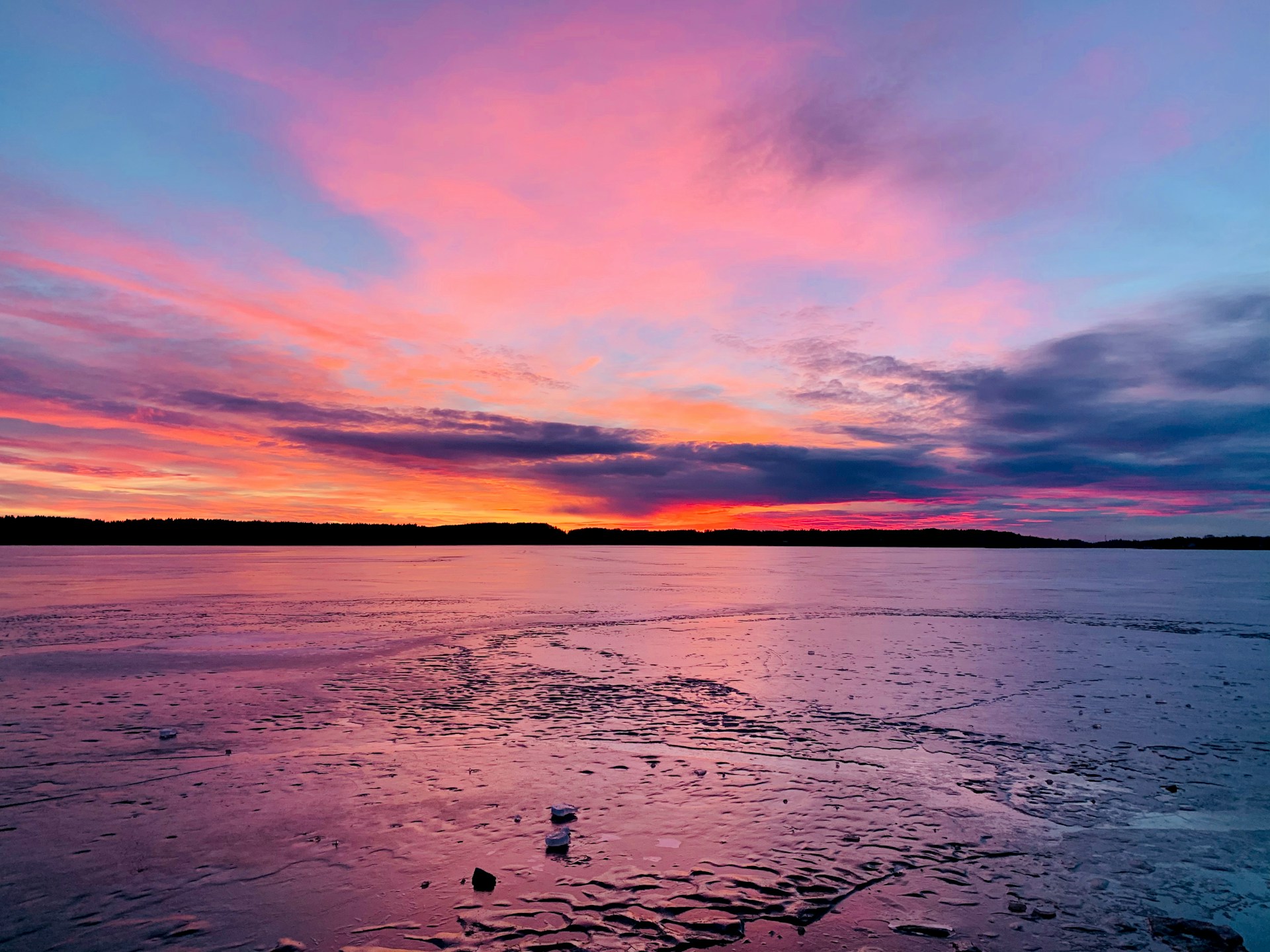 body of water under cloudy sky during sunset