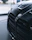 Close-up of BMW accessories displayed neatly on a sleek black and blue background.