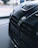 Close-up of BMW accessories displayed neatly on a sleek black and blue background.