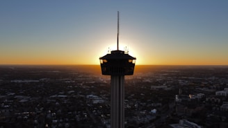 black and white tower during sunset