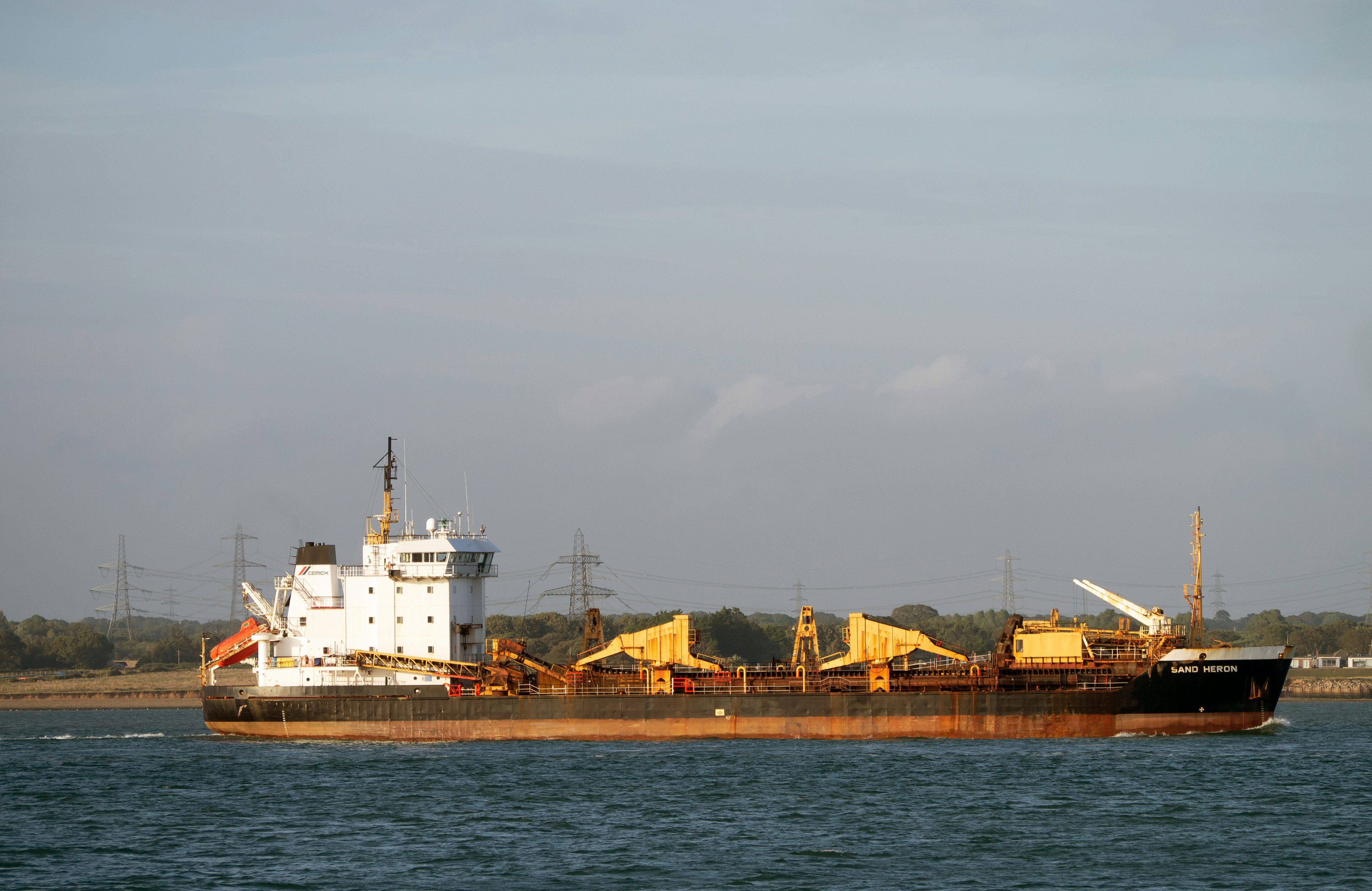 white and brown concrete building near body of water during daytime