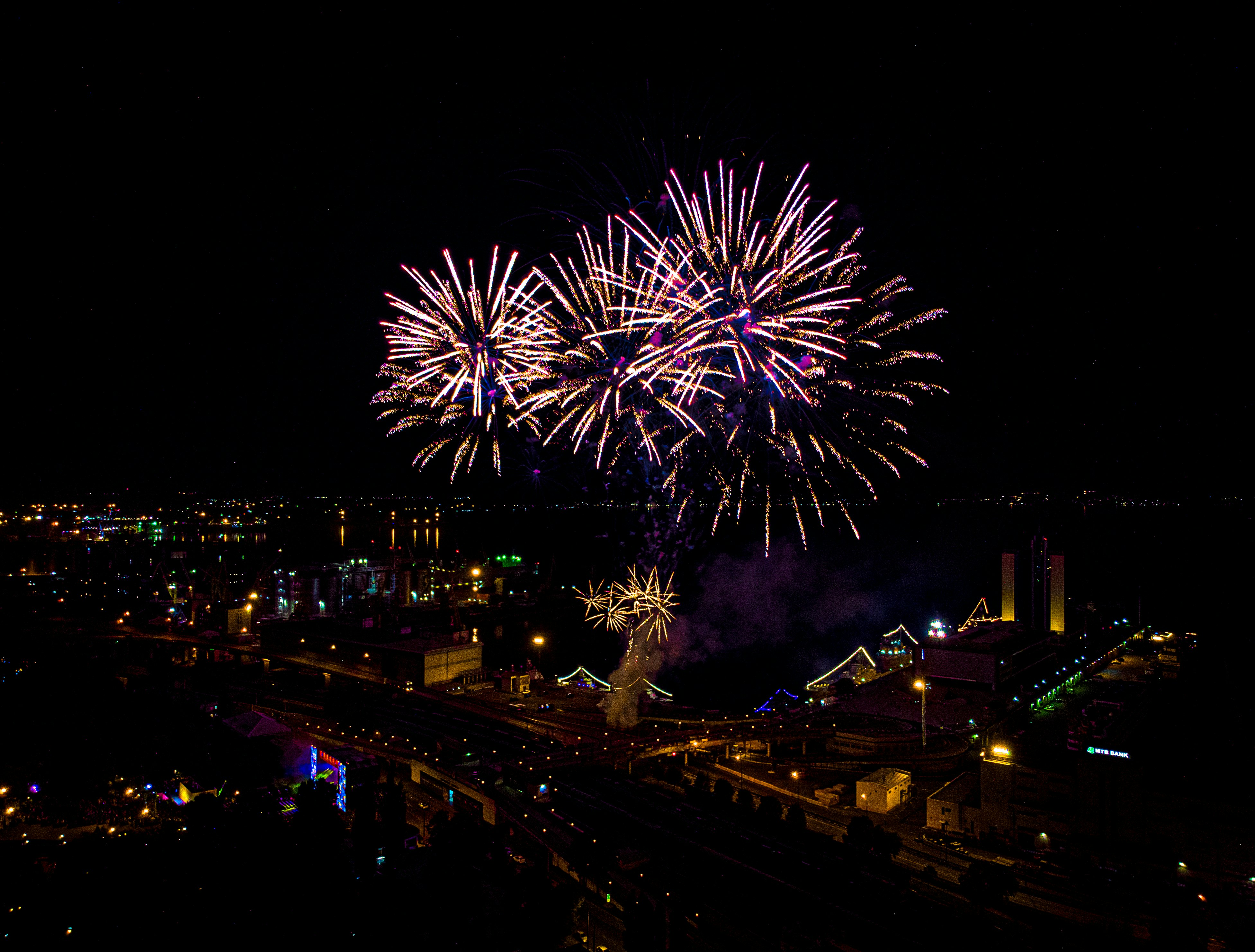 fireworks display over city buildings during night time