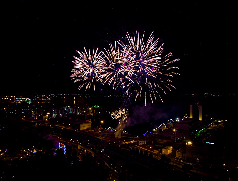 fireworks display over city buildings during night time