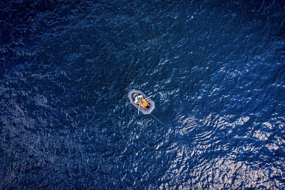 white and blue boat on blue sea during daytime