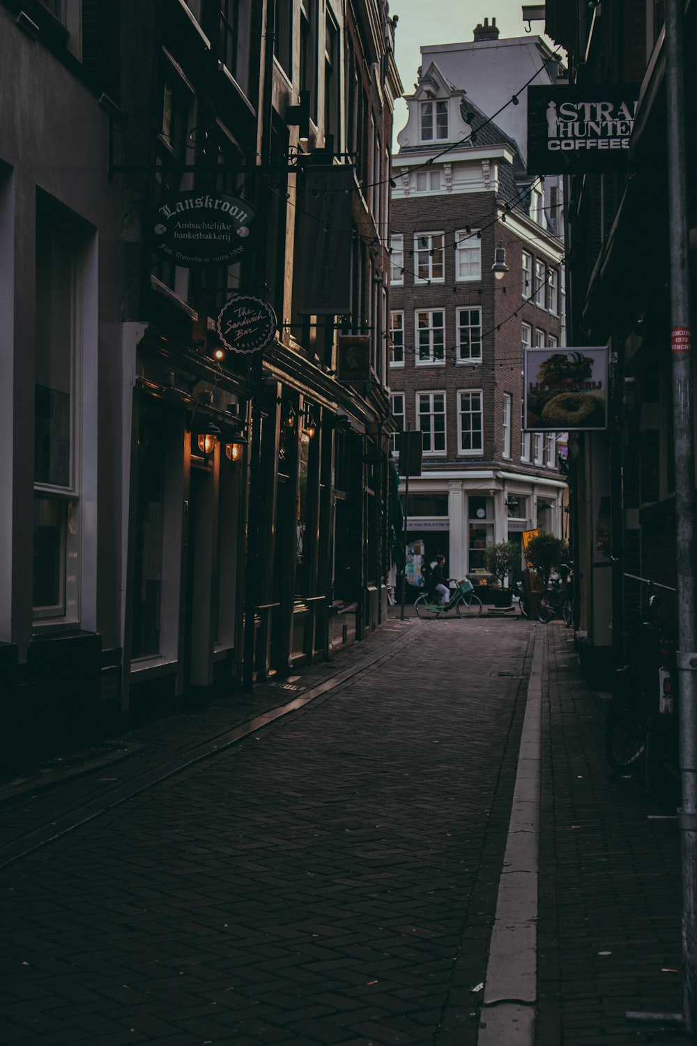 people walking on sidewalk near building during night time