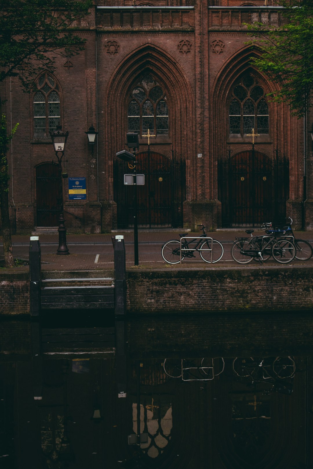 black bicycle parked beside brown building
