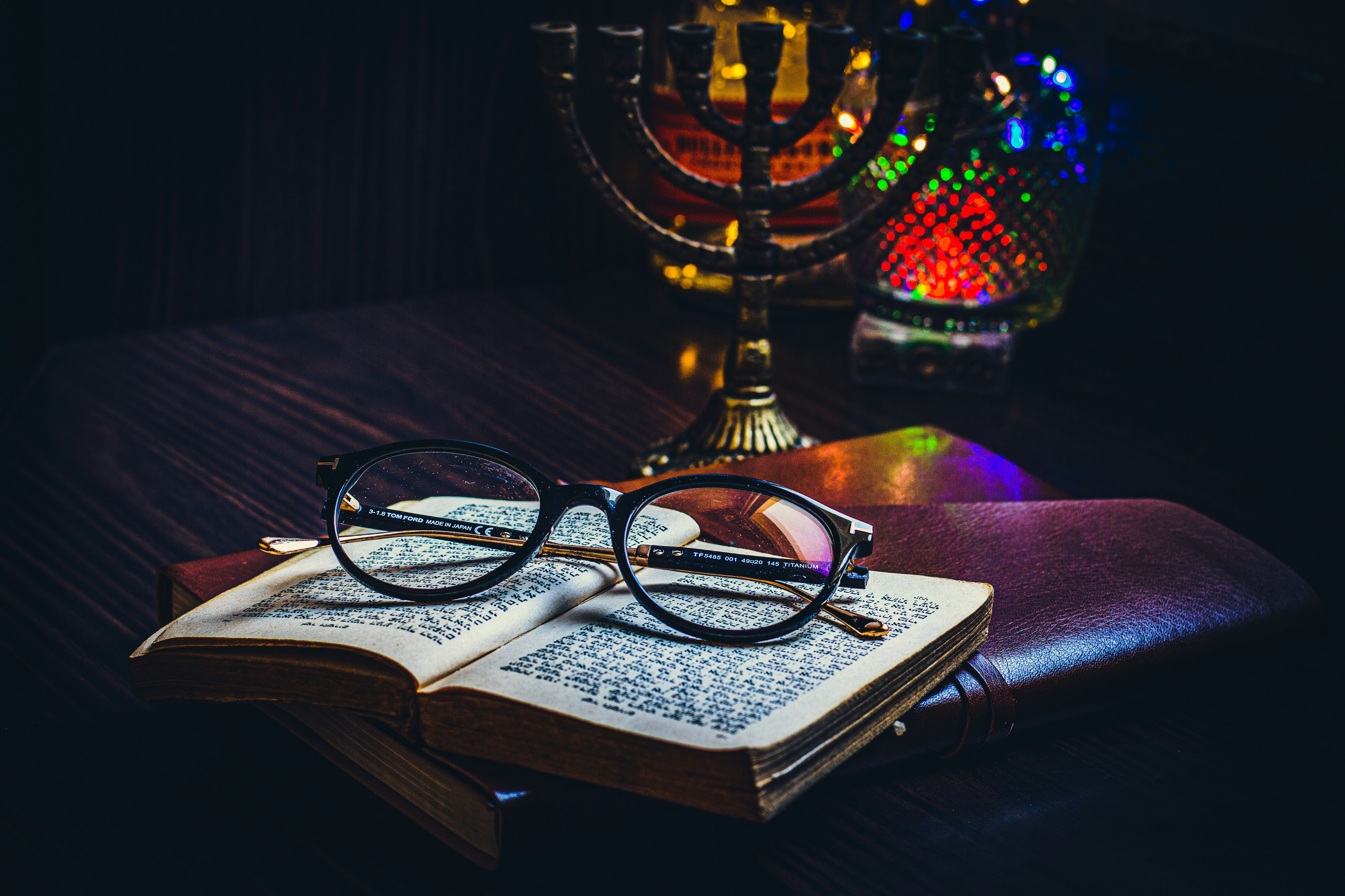 black framed eyeglasses on book page