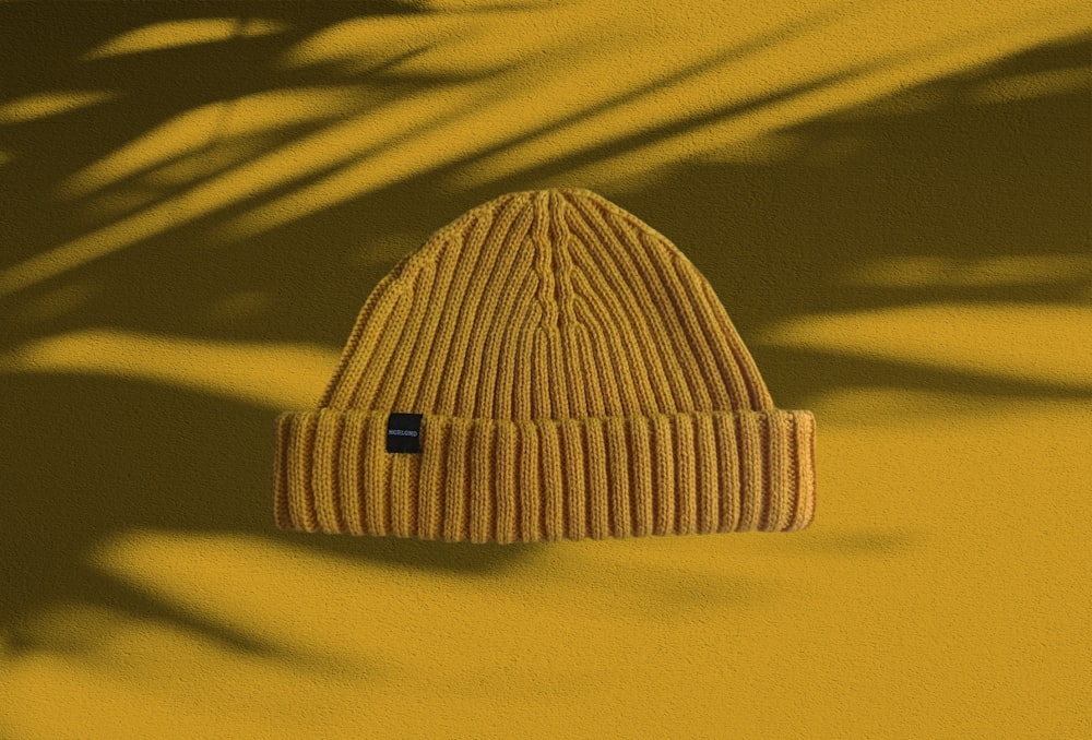white knit cap on yellow textile