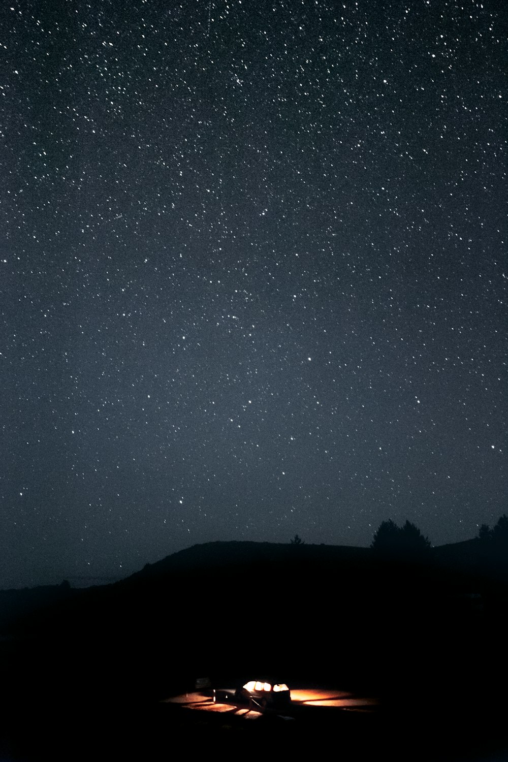 silhouette of mountain under starry night