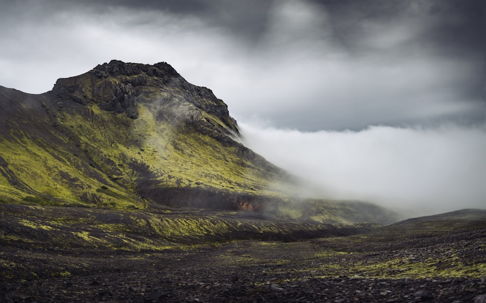 green mountain under white clouds