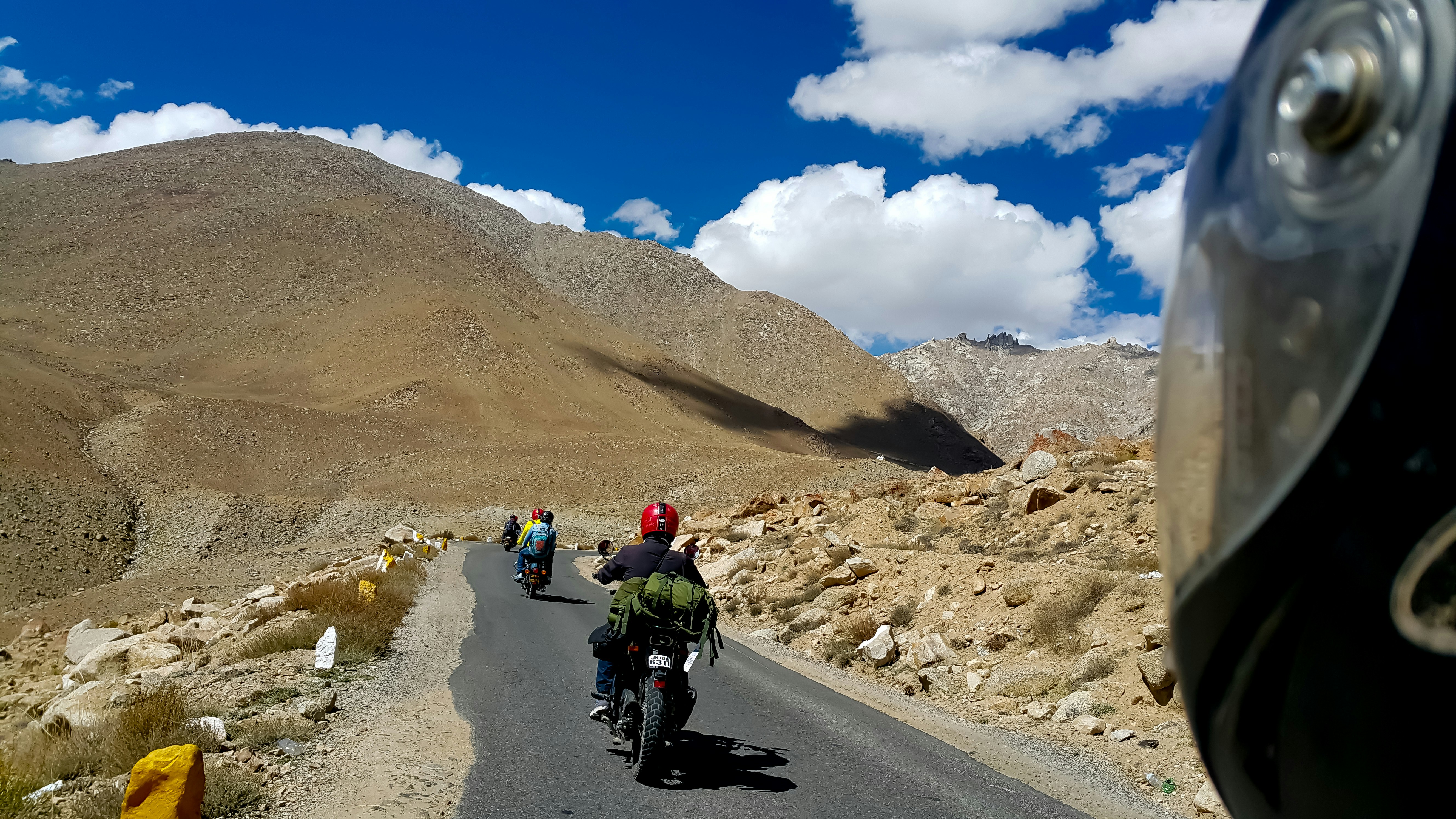 people riding motorcycle on road during daytime