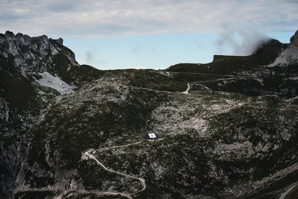 white cable on green grass covered mountain under cloudy sky during daytime