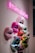 A neon pink sign with the hashtag #makeupkitchen hangs above a series of multicolored, geometric 3D sculptures of lips mounted on a wall. The lips are crafted in various shades, including pink, red, blue, and green, displaying an array of vibrant and metallic textures.