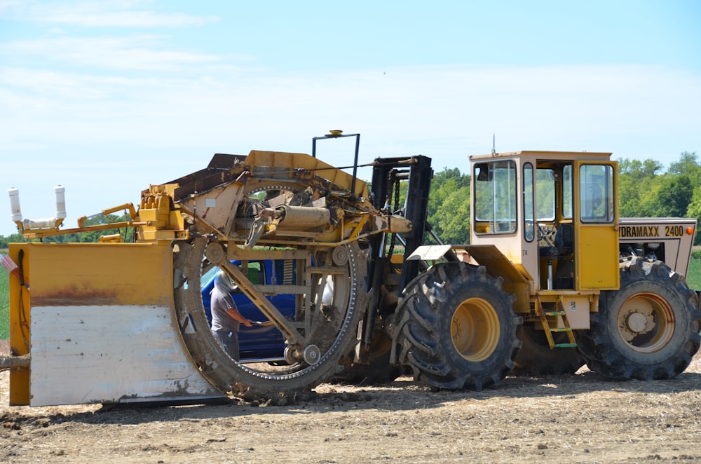 yellow and black heavy equipment on brown sand during daytime